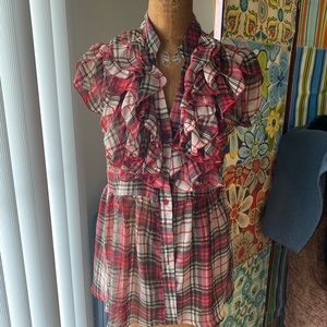 Red plaid blouse with ruffles.